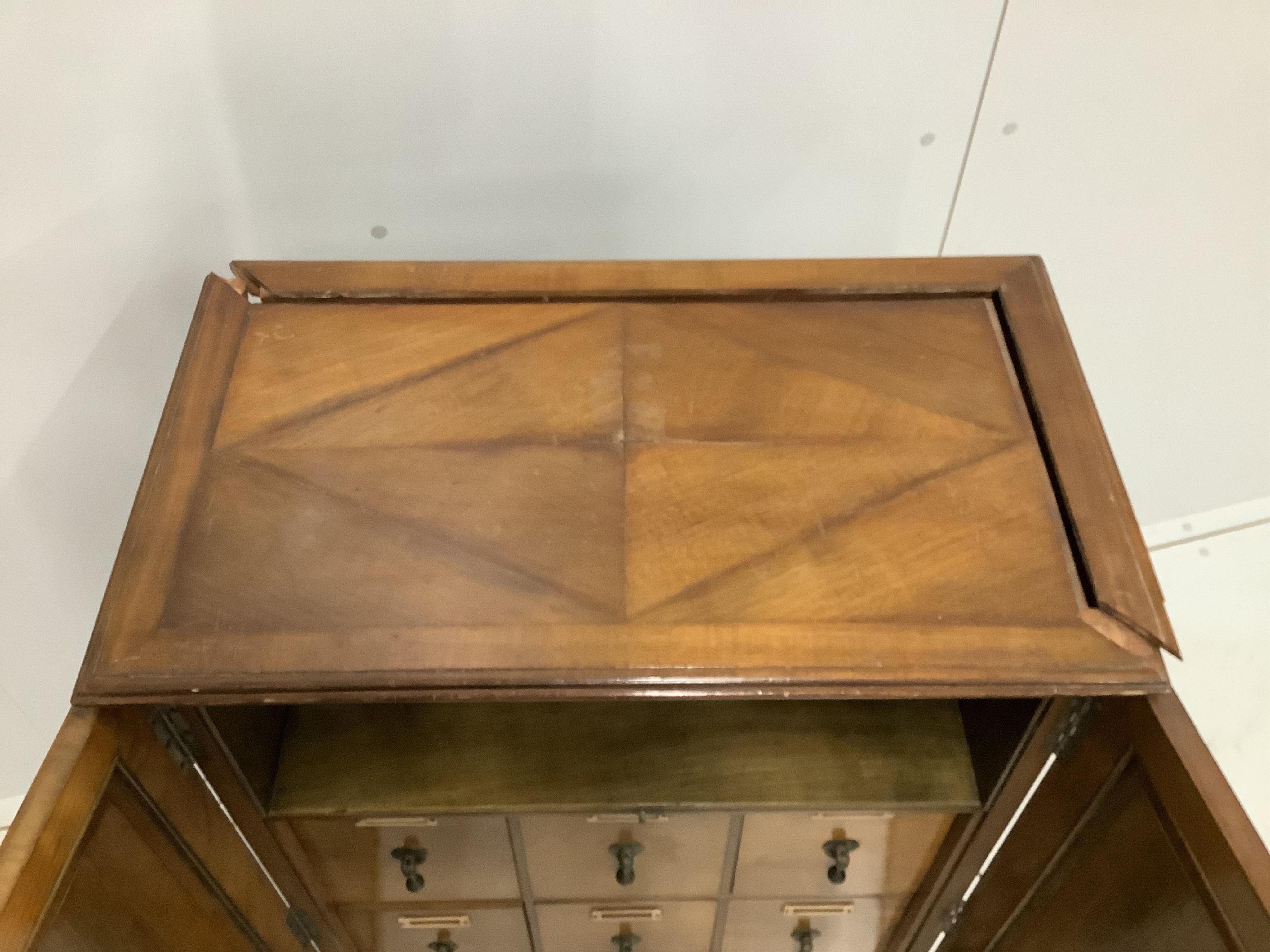 An early 20th century walnut office cabinet fitted with nine deep drawers, width 61cm, height 106cm. Condition - fair, a little faded